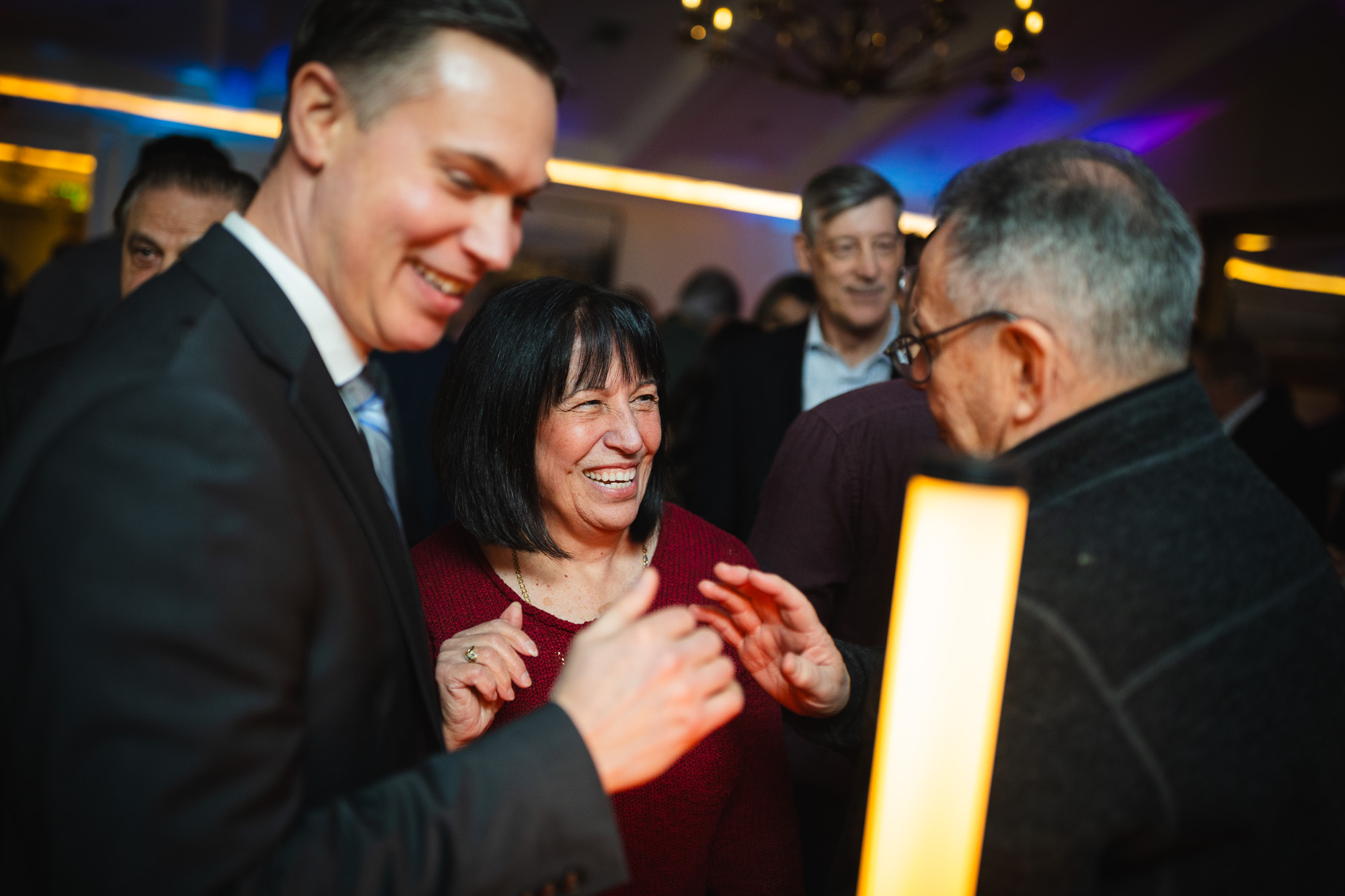 Documentary style event photography capturing authentic business connections at Westport networking event